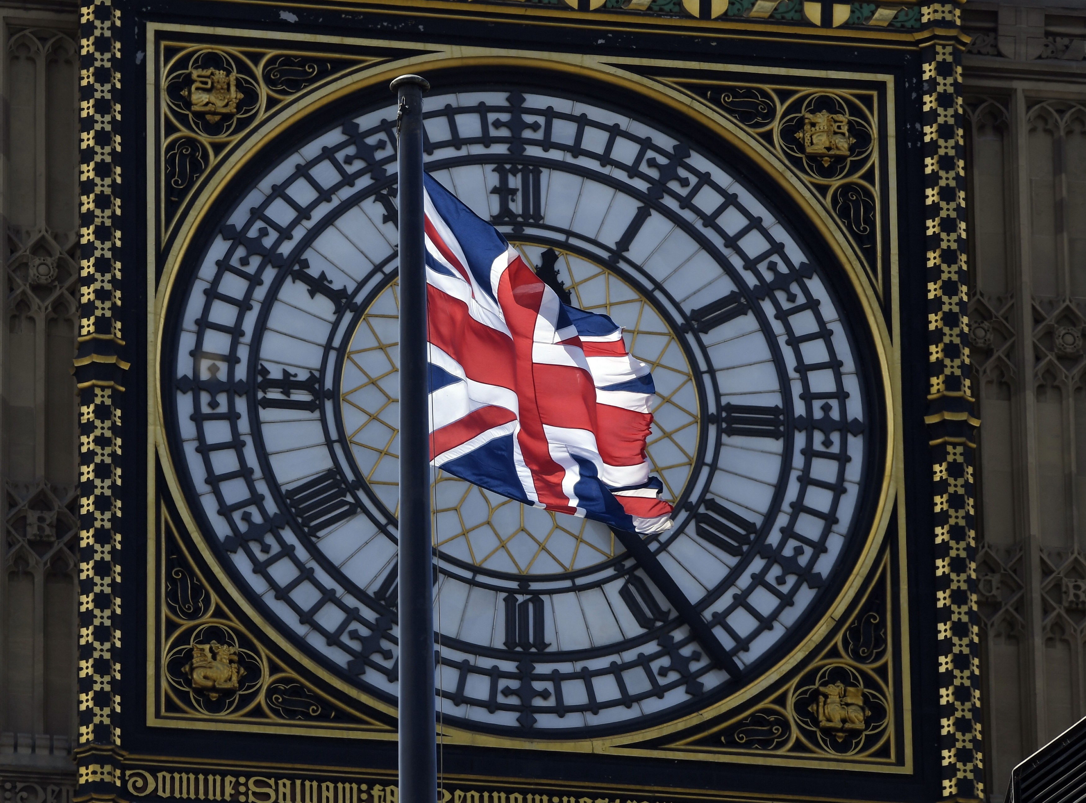A Union Flag flies in front of the Big Ben clock face abover the Houses of Parliament in central London