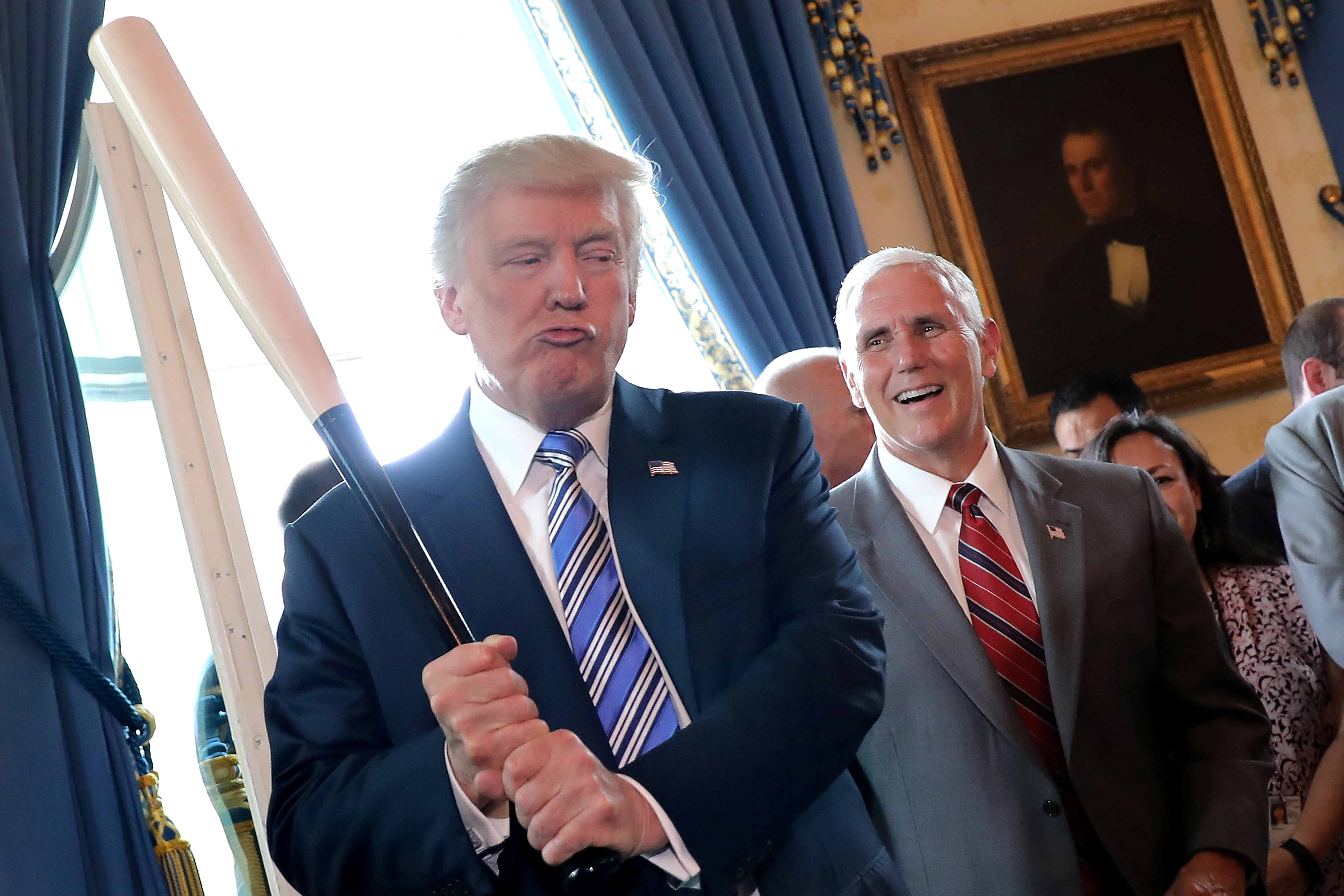 Vice President Mike Pence laughs as U.S. President Donald Trump holds a baseball bat as they attend a Made in America product showcase event at the White House in Washington, U.S.
