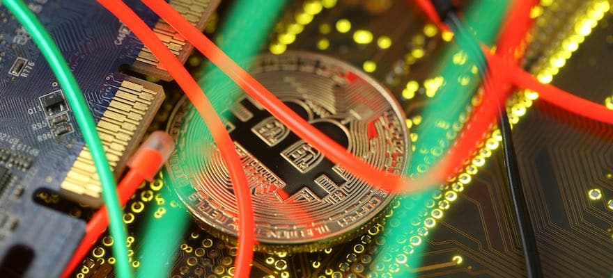 A bitcoin underneath some green and red wires